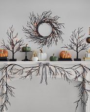 Halloween mantel with themed foliage and pumpkins
