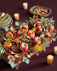 Artificial arrangement with persimmons and pinecones