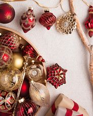 Red and gold vintage-inspired Christmas ornaments on white background