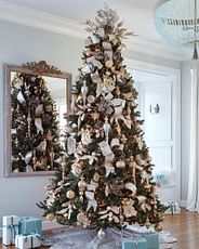Lit Christmas tree with silver and gold ornaments