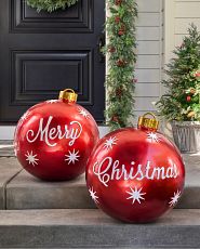 A pair of oversized red ball ornaments with Merry and Christma