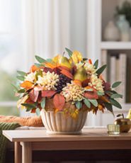Potted fall foliage on a wooden table